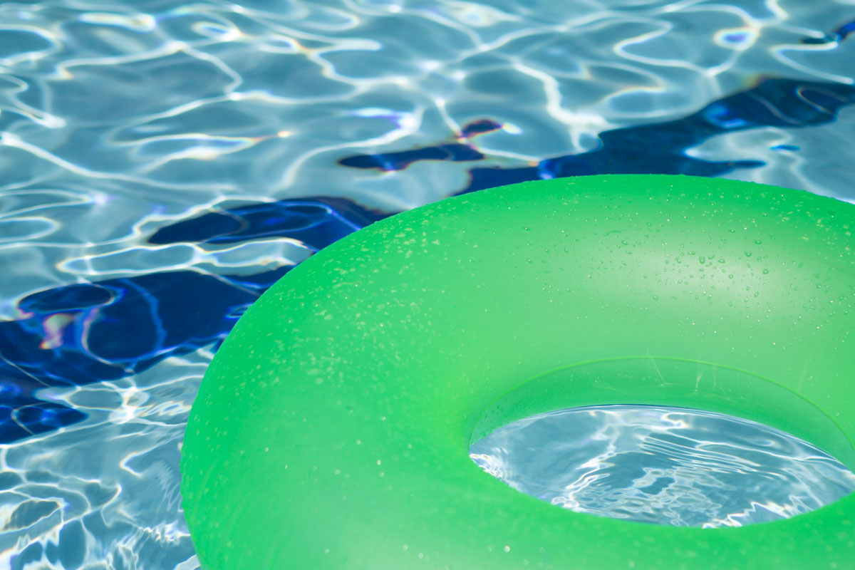 green inner tube floating in a swimming pool